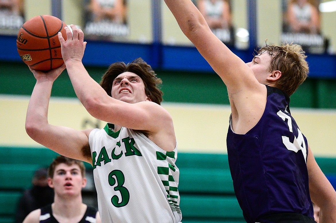 Glacier's JT Allen (3) goes to the hoop against Butte's Jake Olson (34) in the third quarter at Glacier High School on Thursday. (Casey Kreider/Daily Inter Lake)