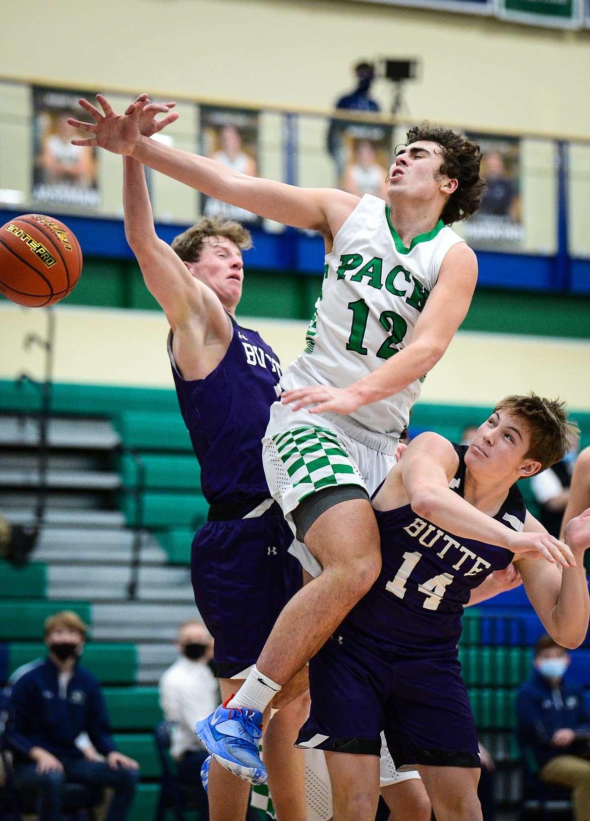 Glacier's Weston Price (12) is fouled on his way to the hoop in the third quarter against Butte at Glacier High School on Thursday. (Casey Kreider/Daily Inter Lake)