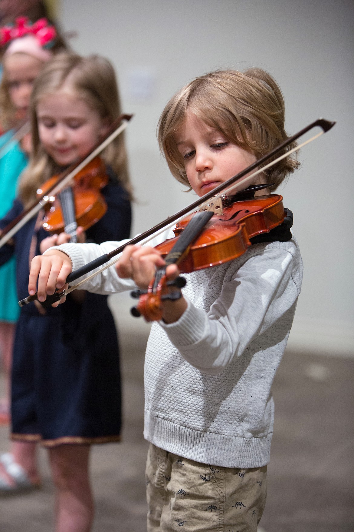 Suzuki String Academy is hosting a pair of open house event this weekend. Above, violin students practice a song.