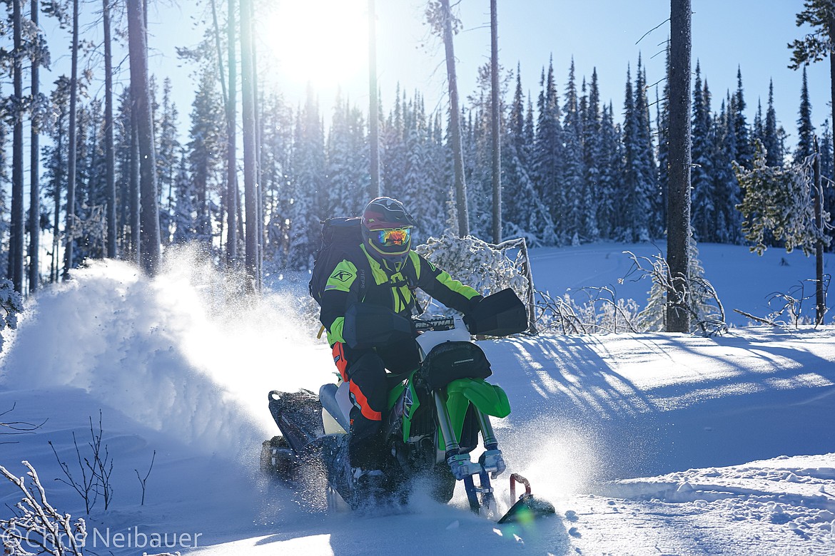 Kyle Allred plows through the snow on a snow bike (Courtesy photos).
