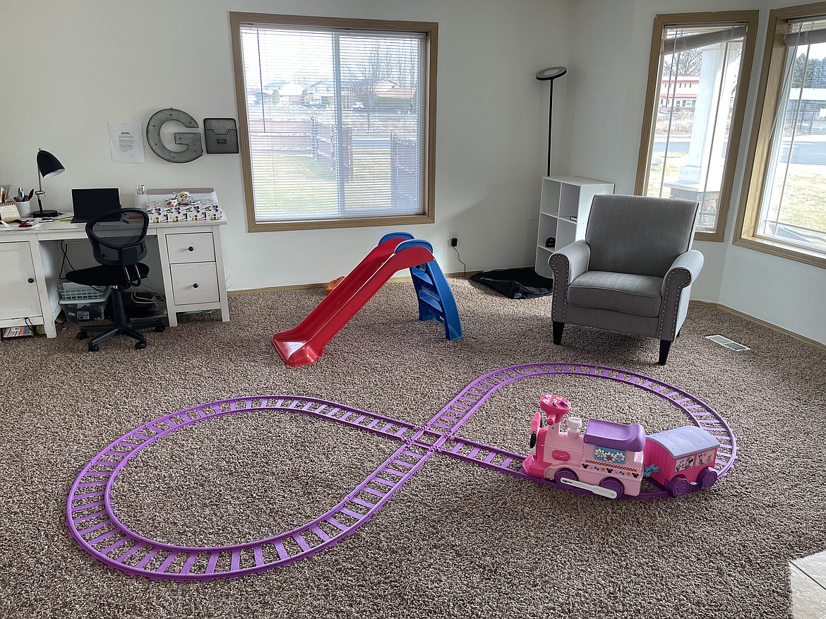 Moving from a 1,200 square-foot apartment to a 2,200 square-foot home in Moses Lake means the Graveses don't have a lot of furniture, Joel Graves said. Which leaves room for the toy train that Joy rides. "It was a good investment," Joel said of the train.