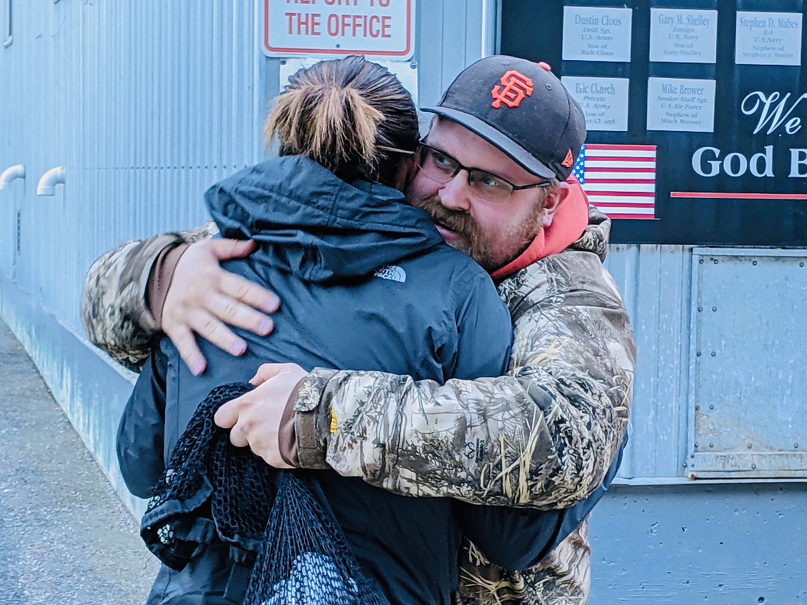 Griff Rasmussen hugs his wife Kami — who was waiting for him at the surface on Thursday morning. Rasmussen was one of 60 miners who remained underground during a power outage at the Galena Mine.