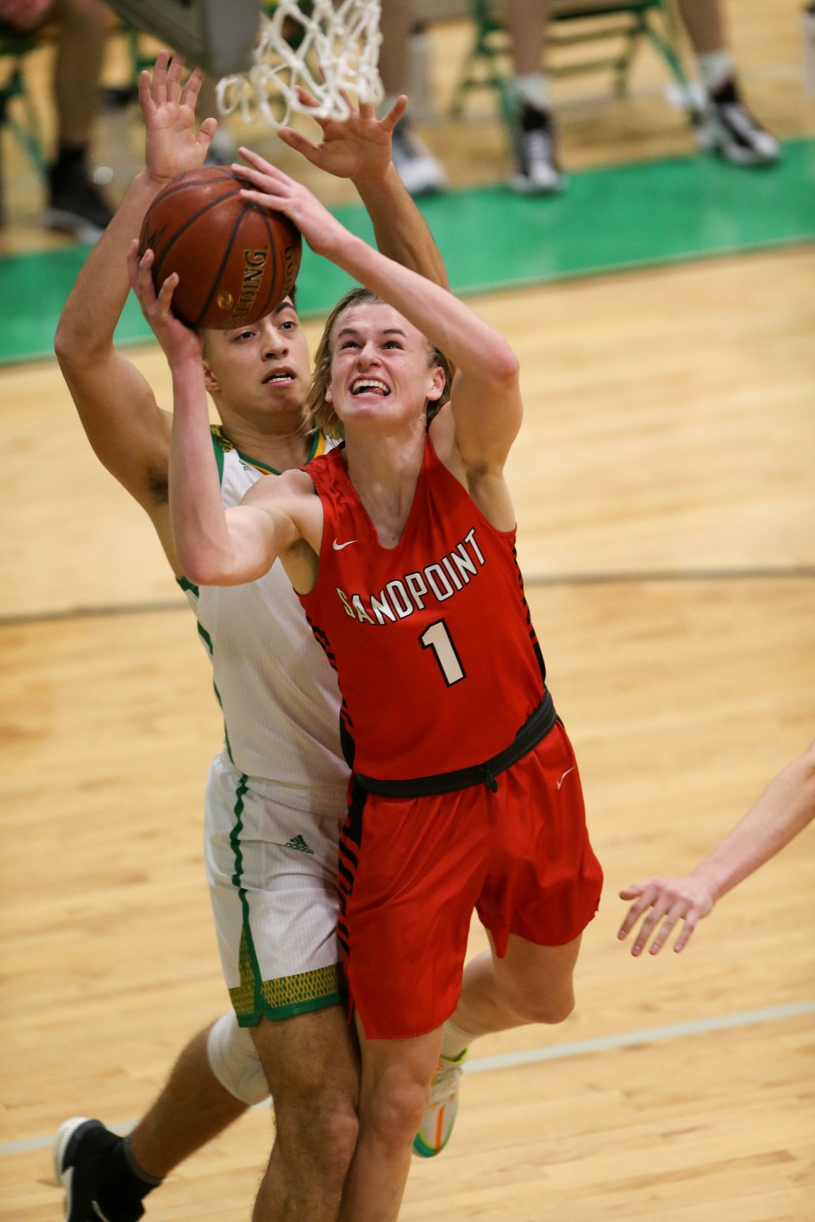 Sophomore Colin Roos fights through the Lakeland defense and attempts a layup on Friday night.