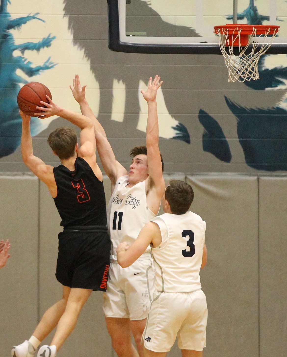 MARK NELKE/Press
Zach Johnson of Lake City challenges a shot by Caden McLean of Post Falls, and Ben Janke (3) of Lake City defends Friday night.