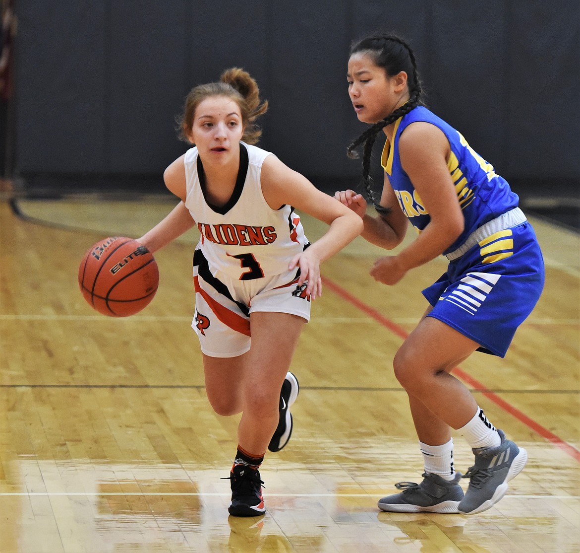 Alexis Wirz (3) drives past Libby defender Rub Martin. (Scot Heisel/Lake County Leader)