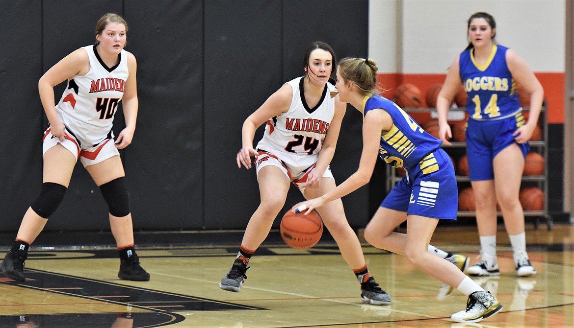 Libby's Rylee Boltz drives toward the Maidens' Madeline McCrea (24) and Jaylea Lunceford (40) as Gabby Fantazzi (14) watches in the background. (Scot Heisel/Lake County Leader)