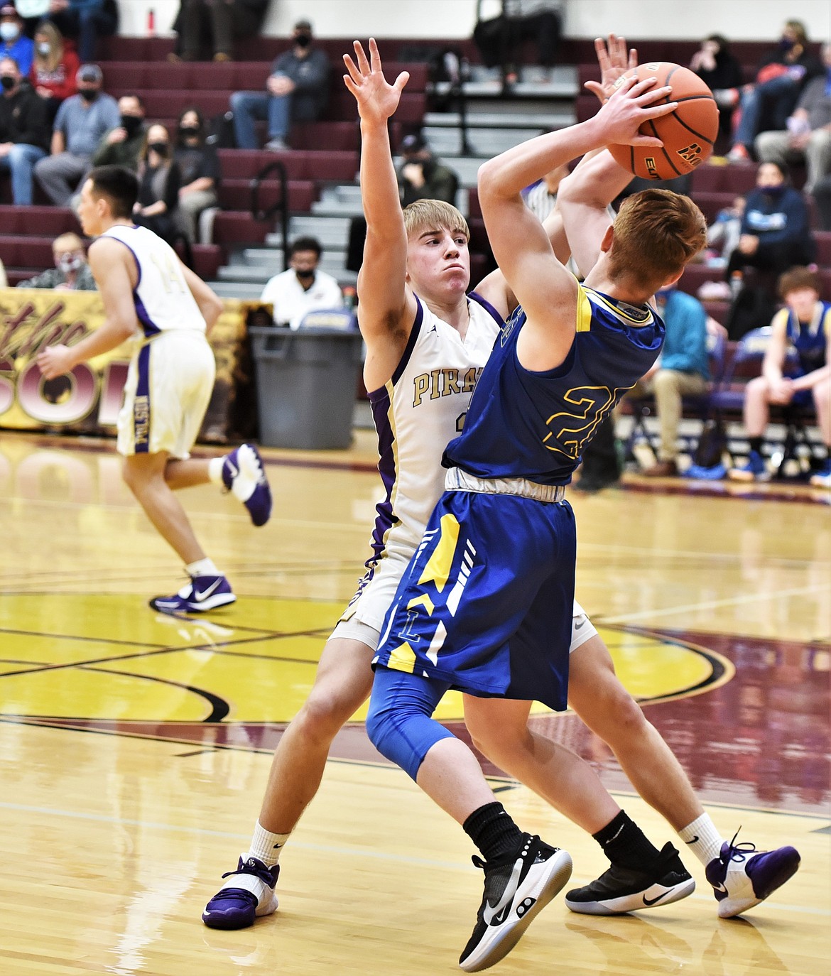 JC Steele turns on the defensive pressure against Libby guard Ryan Collins. (Scot Heisel/Lake County Leader)