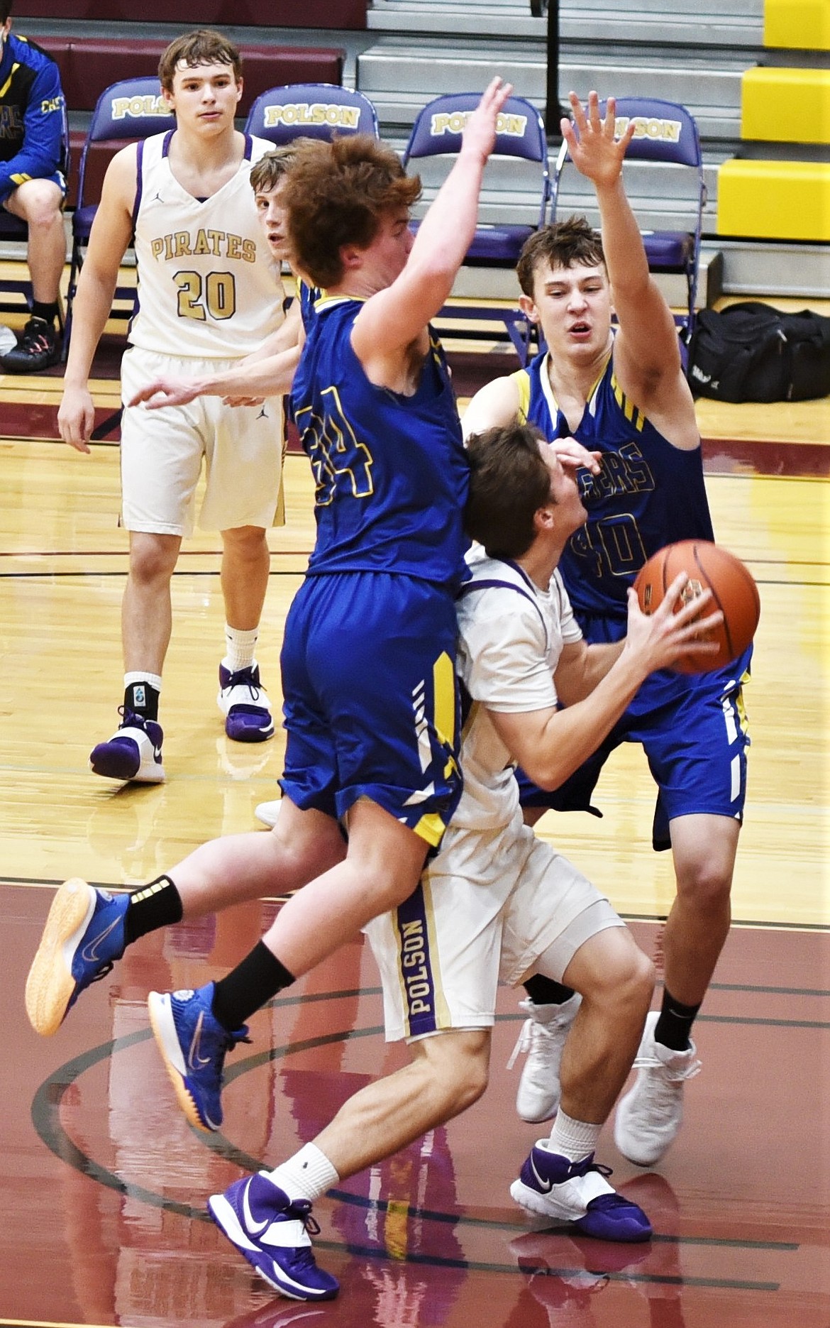 Libby's Ryker McElmurry (34) and TJ Andersen (40) defend against Xavier Fisher as Jarrett Wilson (20) watches in the background. (Scot Heisel/Lake County Leader)