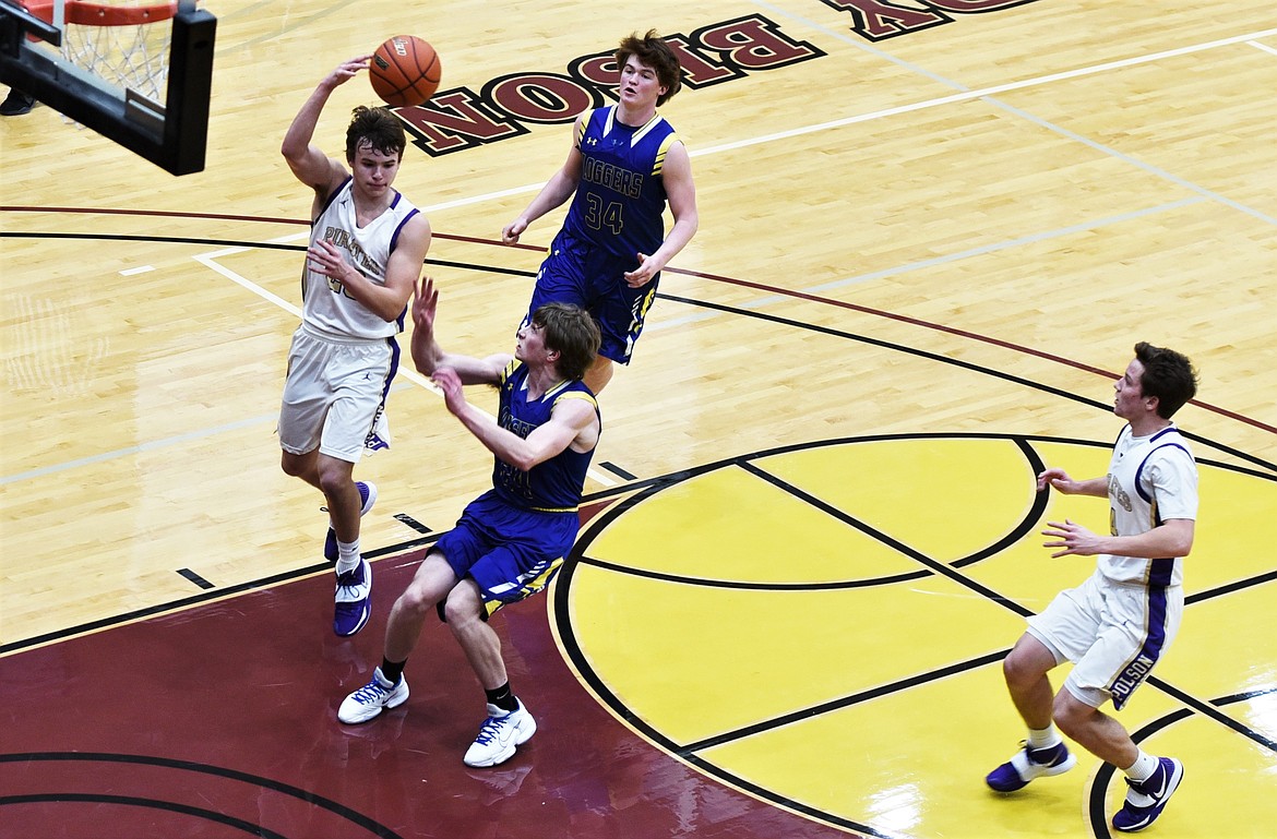 Polson guard Jarrett Wilson dishes a pass to Xavier Fisher during a fast break against Libby. (Scot Heisel/Lake County Leader)