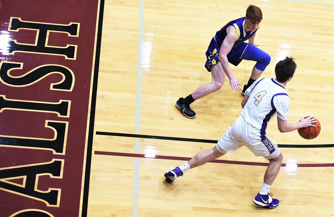 Libby's Caden Williams (32) matches up with Polson guard Xavier Fisher. (Scot Heisel/Lake County Leader)