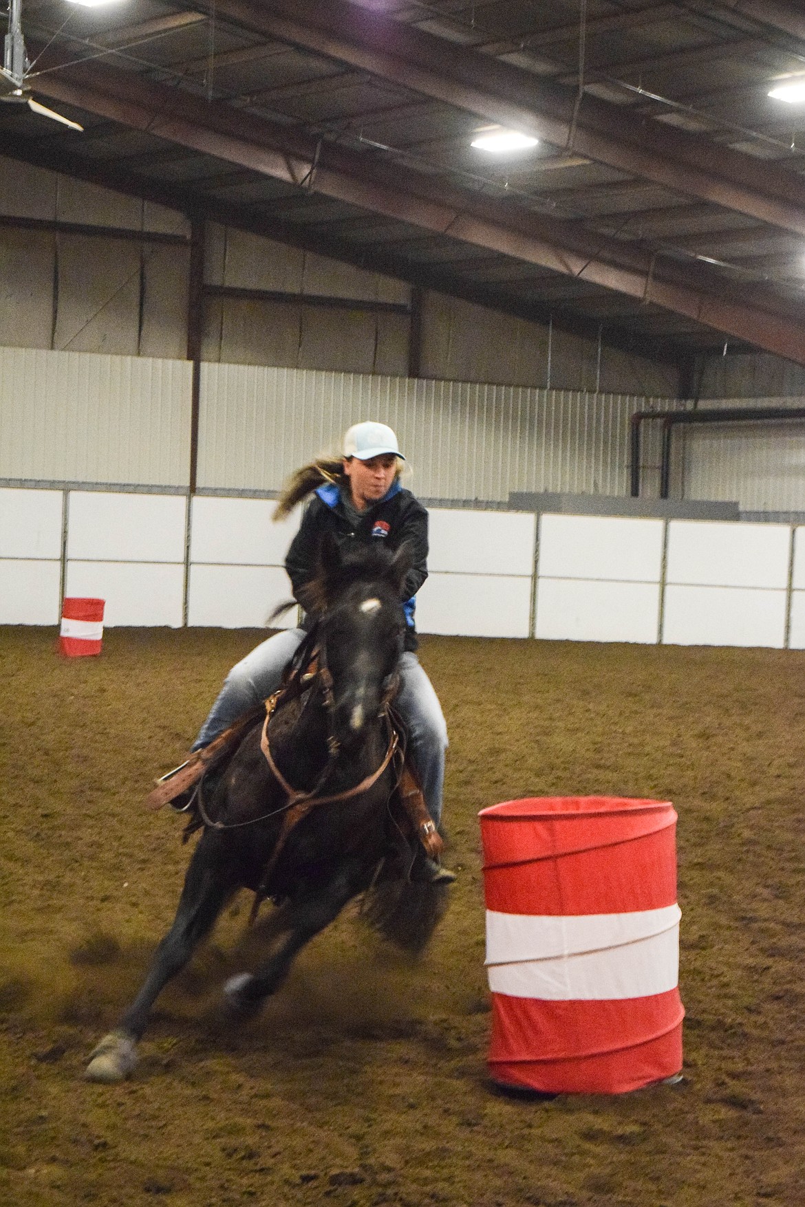 A Moses Lake barrel racer rounds her second barrel.