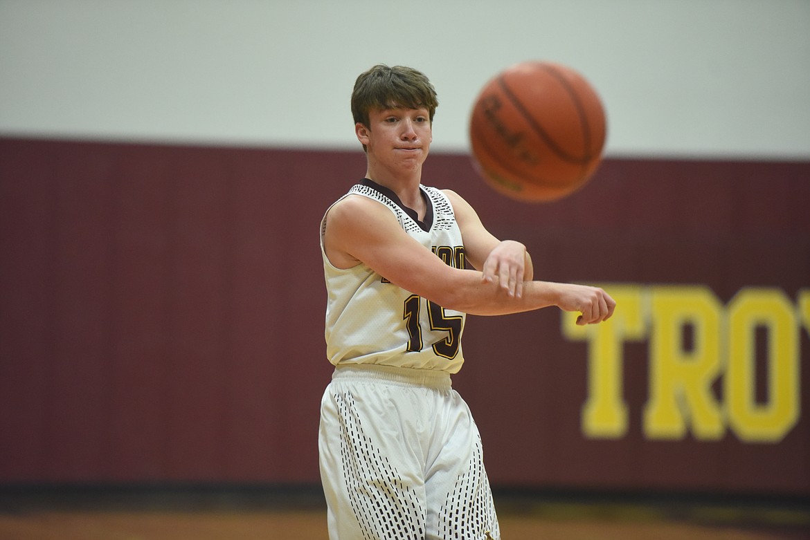 Junior Tyler Munts launches a pass during the Trojans' Jan. 16 game against Eureka. (Will Langhorne/The Western News)