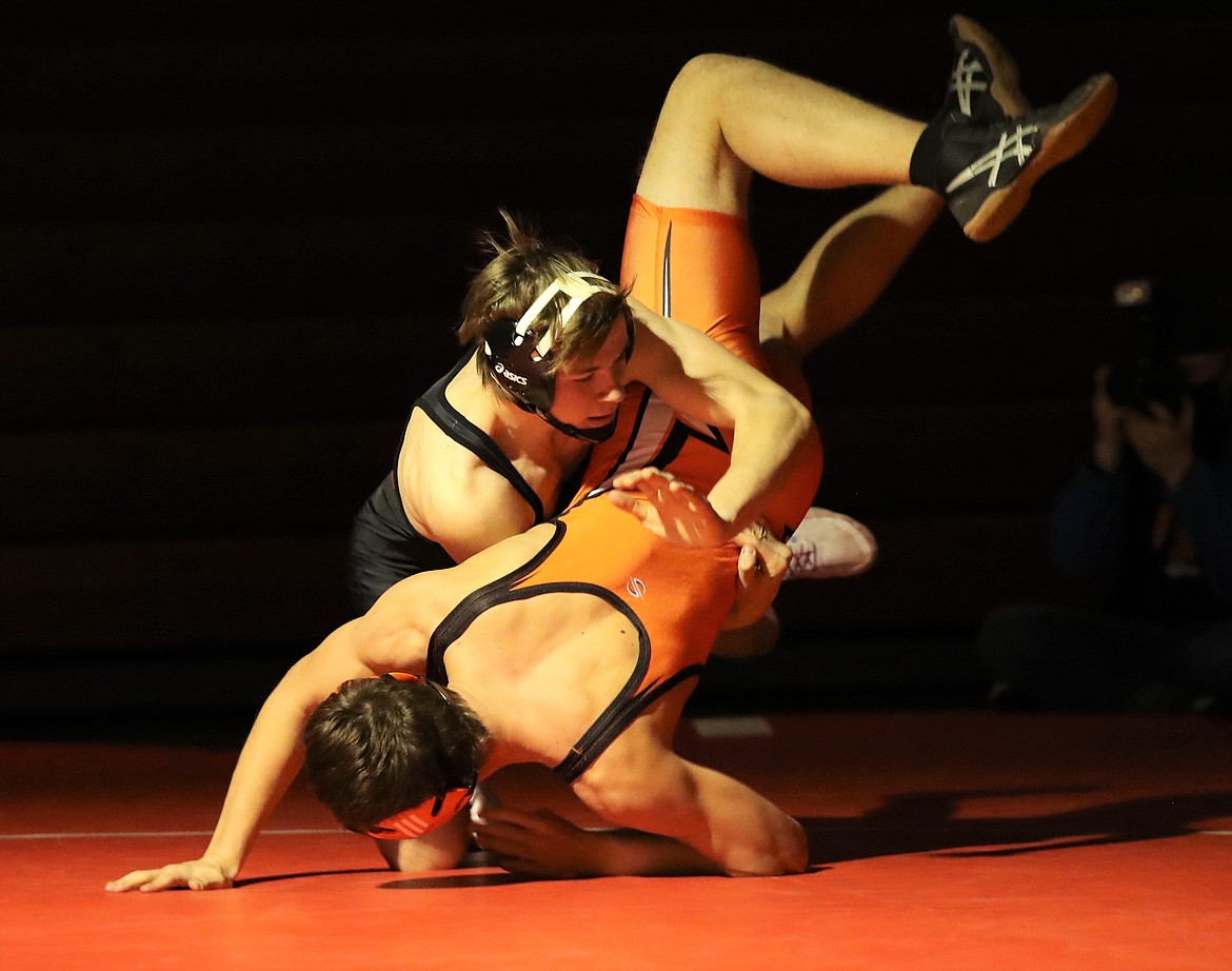 Senior Trevan Adam (top) takes down Priest River's Keegan Poirier in a 152-pound match on Dec. 4 at Les Rogers Court.