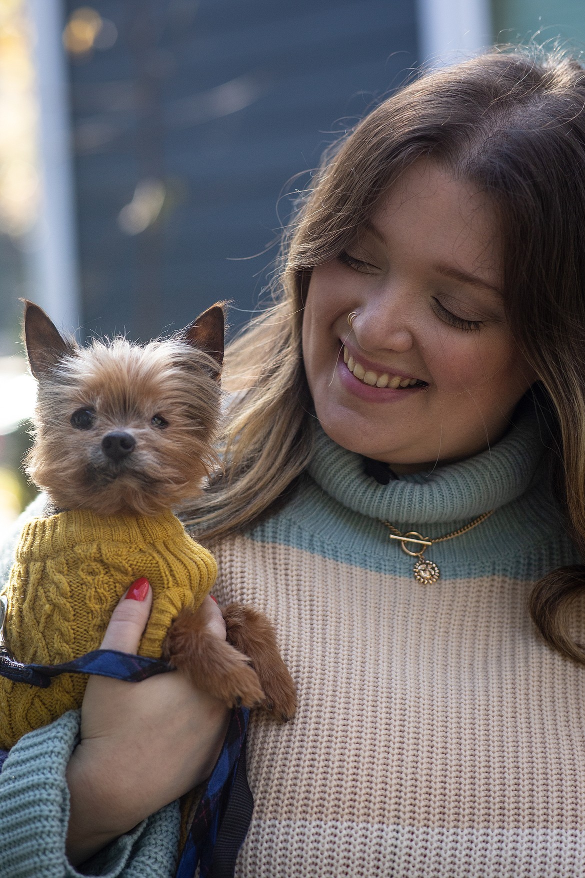 Kursten Hedgis holds her dog Bitsy in front of her home Dec. 9, 2020, in Decatur, Ga. Bitsy is 14 and has been with her six years after a life as a breeder in a puppy mill. He is blind in one eye and suffers periodic infections and incontinence. Trips to the veterinarian have been “really scary” because of the masks and reduced contacts. However, Hedgis and other pet owners say they have become more than companions in recent months, that they provide valuable emotional support to their humans.