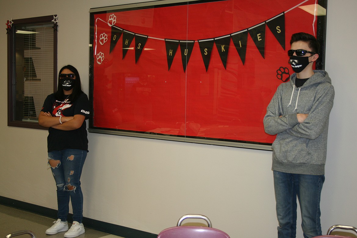 Loryn Maples (left) and Jack Gentry (right) lay down what will be the law in the Othello High School cafeteria. The aSB officers were asked by OHS administrators to produce a video explaining the rules kids will be required to live by in an attempt to reduce the spread of coronavirus.