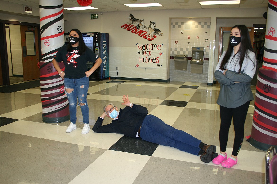 Othello High School assistant principal Jim Wood (center) and ASB officers Loryn Maples (left) and Cindy Magana (right) demonstrates what six feet really looks like in a video produced by the ASB officers. The video shows OHS students some of the new rules required when school reopens Jan. 25.