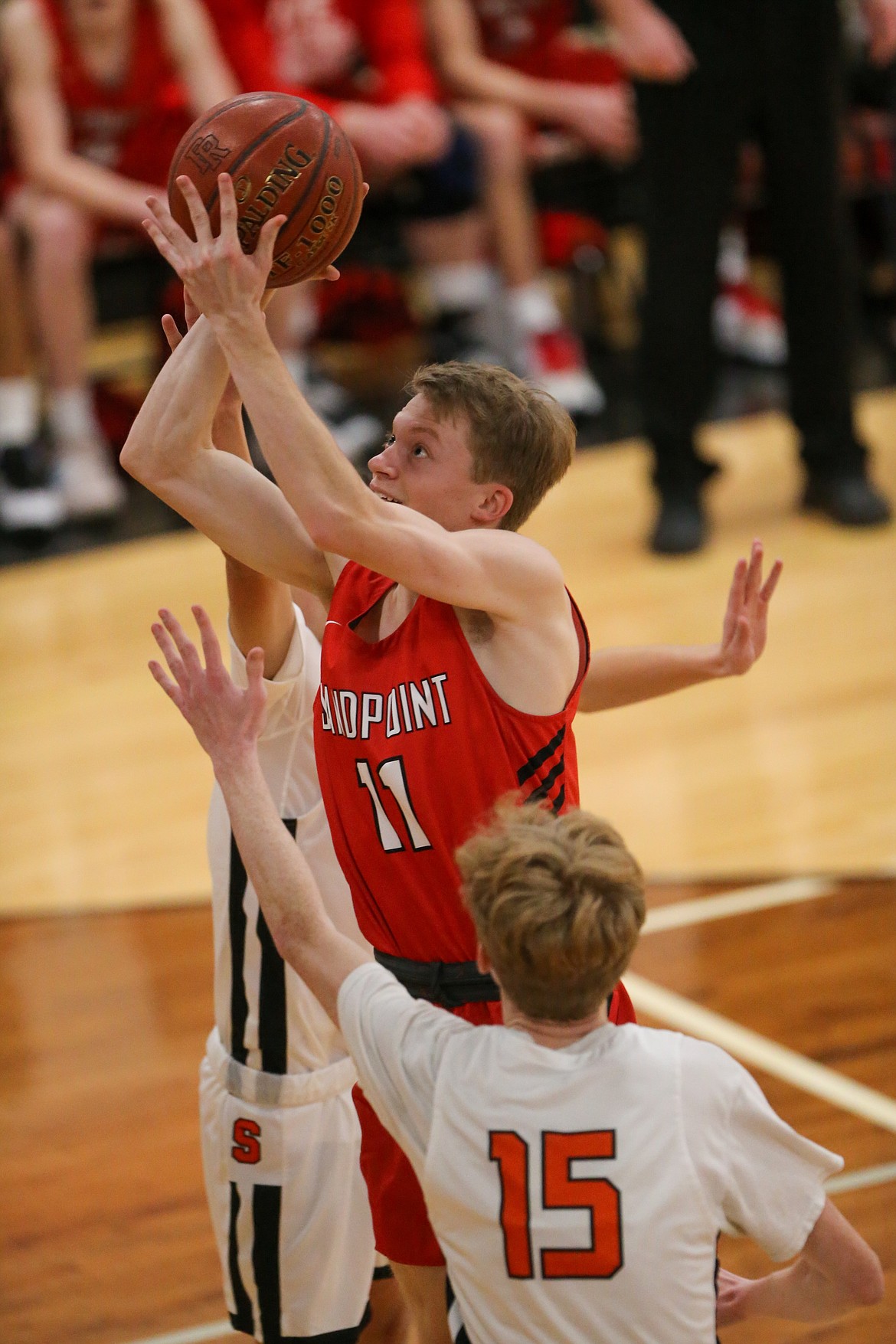 Sandpoint senior Darren Bailey pulls up for a jumper over a pair of Priest River defenders on Tuesday.