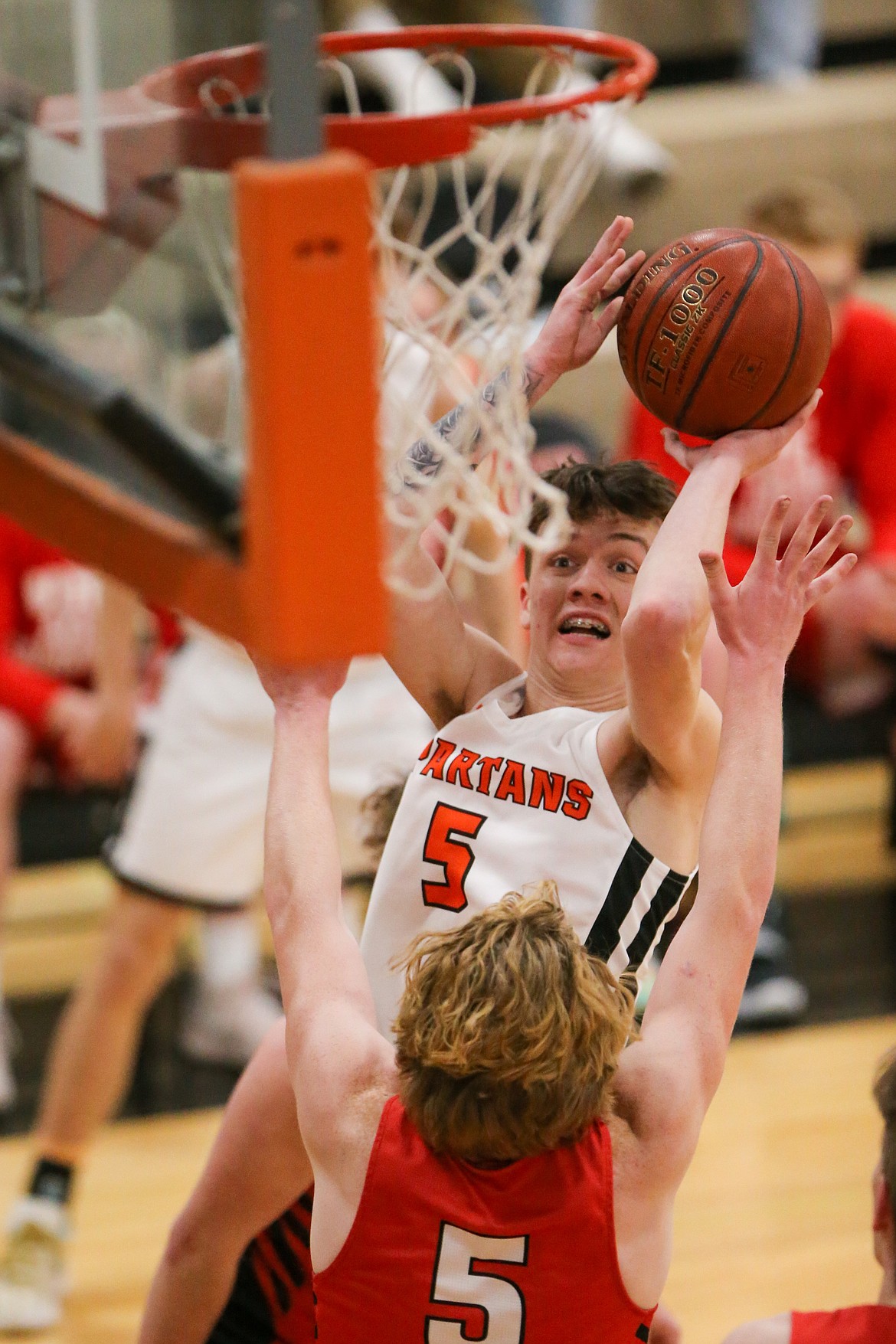 Priest River junior Trenytn Kreager attempts to knock down a shot over a Sandpoint defender on Tuesday.
