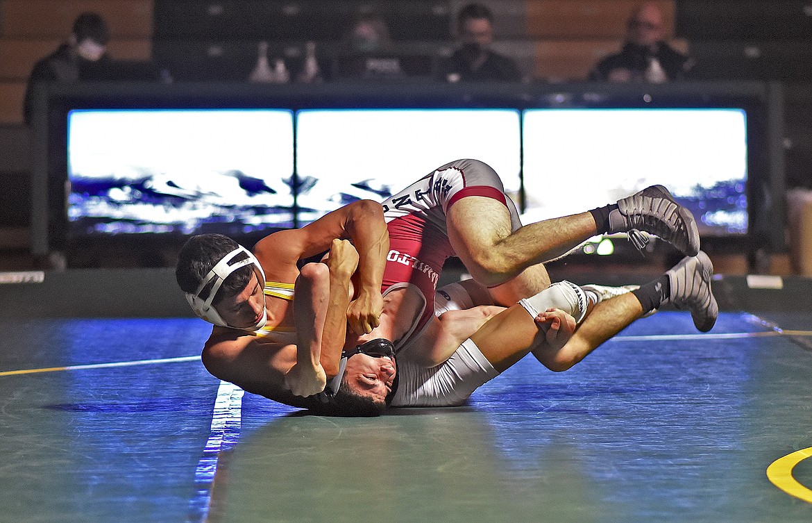 Bulldog Angelo Castro shows control as he wrestles Jesse Anson from Hamilton on Saturday. Castro won by a 11-6 decision. (Whitney England/Whitefish Pilot)