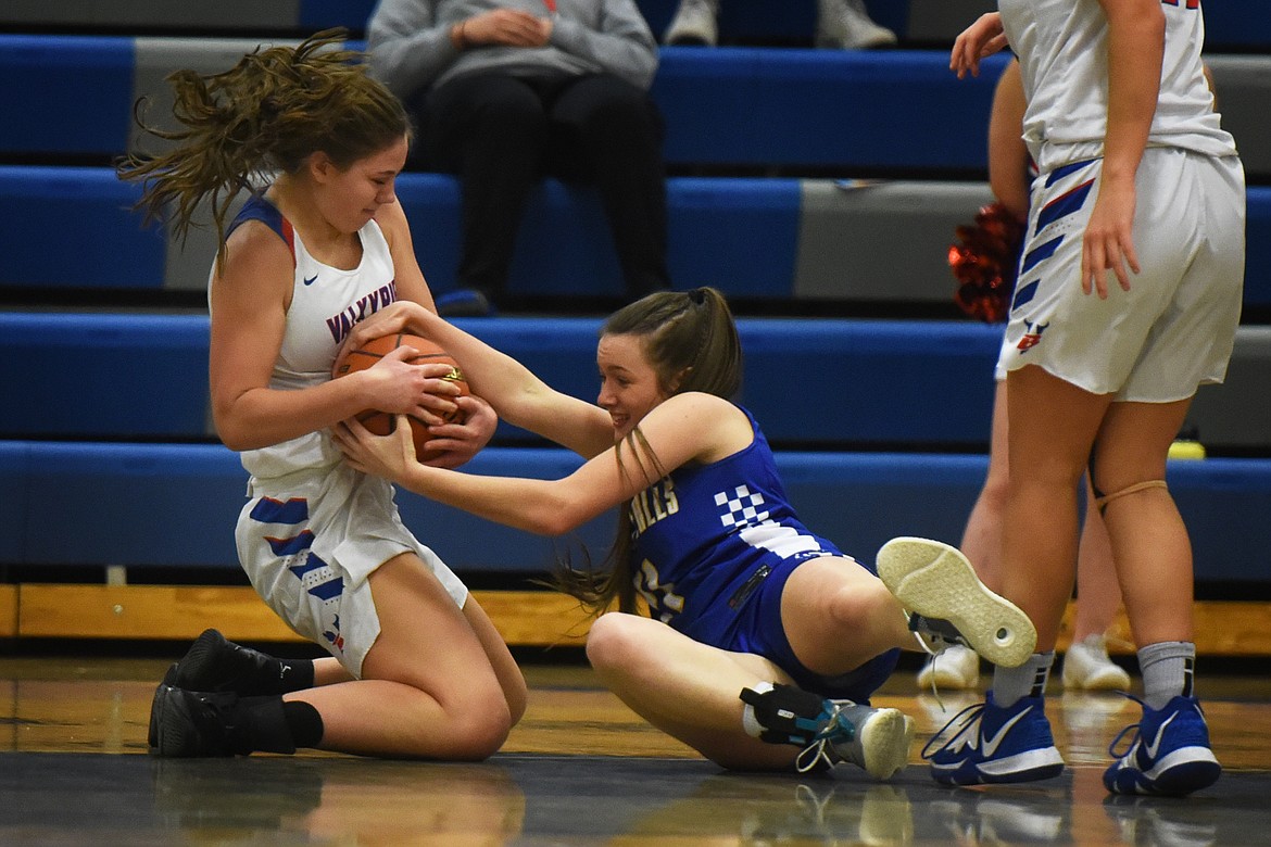 Madison Chappuis battles with Lady Blue Hawk Caity Alexander for a loose ball Thursday.
Jeremy Weber