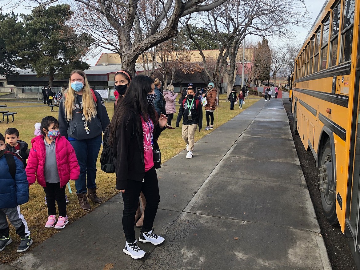 A Wahluke Junior High student waits to board the school bus after returning for in-person instruction for the first time since March. District principals said the return to school in a hybrid (part time) schedule has been going fairly smoothly.