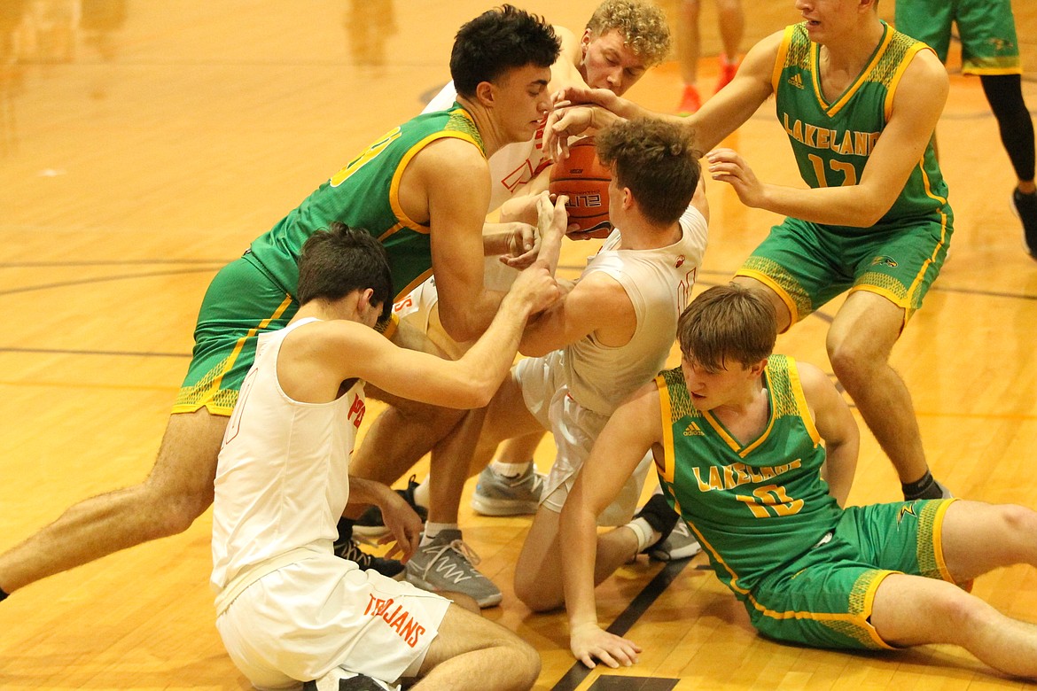 MARK NELKE/Press
Ammon Munyer, left, of Lakeland, and Cole Rutherford of Post Falls battle for a loose ball Tuesday night at Post Falls. Also part of the scrum are Riley Peterson (10) and Isaac Ballew, rear, of Post Falls, and Carson Seay (10) and Abe Munyer (12) of Lakeland.