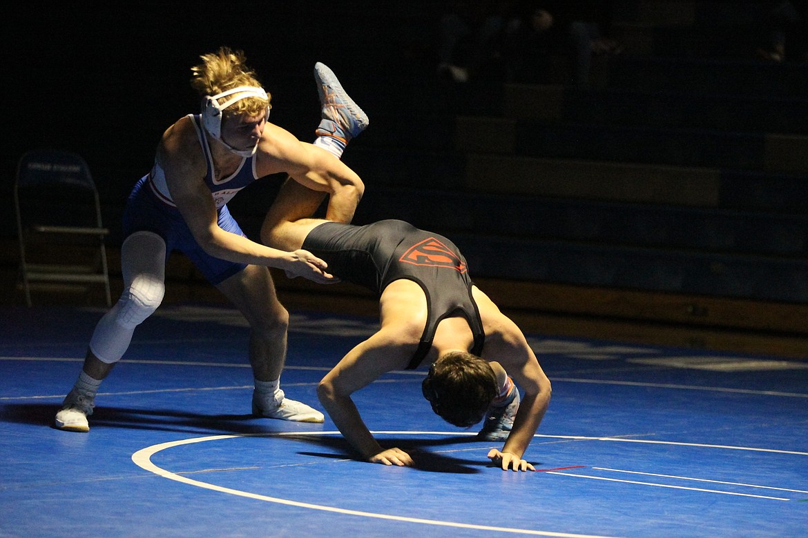 JASON ELLIOTT/Press
Coeur d'Alene wrestler Gunner Giulio keeps a grip on the leg of Sandpoint's Christian Troumbley-Karkowski during their bout at 170 pounds on Wednesday.