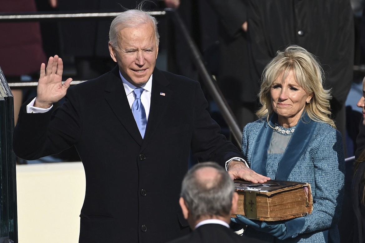 Joe Biden is sworn in as the 46th president of the United States by Chief Justice John Roberts as Jill Biden holds the Bible during the 59th Presidential Inauguration at the U.S. Capitol in Washington, Wednesday, Jan. 20, 2021.