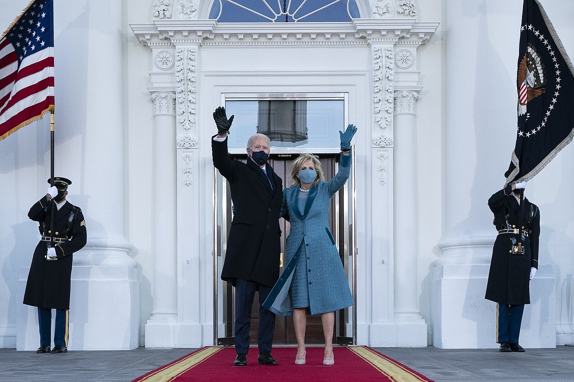 President Joe Biden and first lady Jill Biden wave as they arrive at the North Portico of the White House, Wednesday, Jan. 20, 2021, in Washington. (AP Photo/Alex Brandon, Pool)