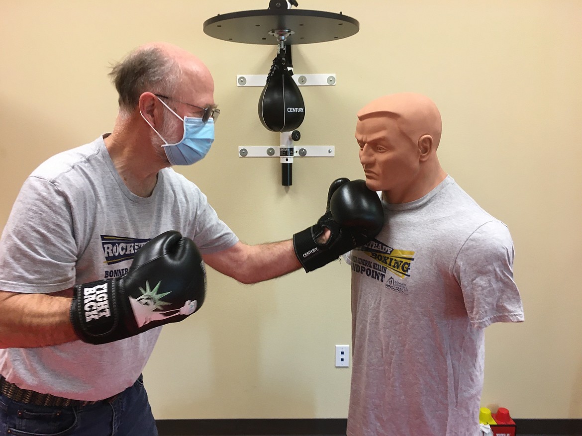 A.C. Woolnough works out with a boxing dummy during a recent Rock Steady Boxing class.