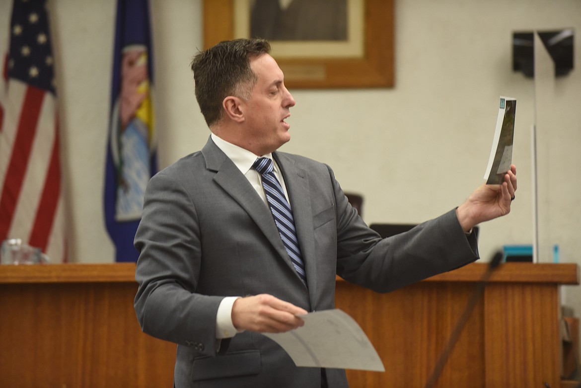 State prosecutor Dan Guzynski shows a crime scene photo to the jury Thursday during the Danielle Wood murder trial in the Sanders County Courthouse in Thompson Falls. Wood is accused of killing her ex-boyfriend, Matt LaFriniere, May 2, 2018. (Scott Shindledecker/Valley Press)