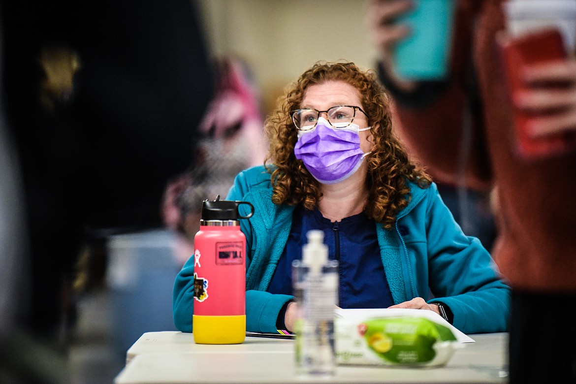 Amy Keith, a school health aide, checks in students after they're screened for COVID-19 symptoms at Columbia Falls High School on Wednesday, Jan. 20. Keith and school nurse Angie Tamburelli were hired by the school for COVID-19 mitigation. (Casey Kreider/Daily Inter Lake)