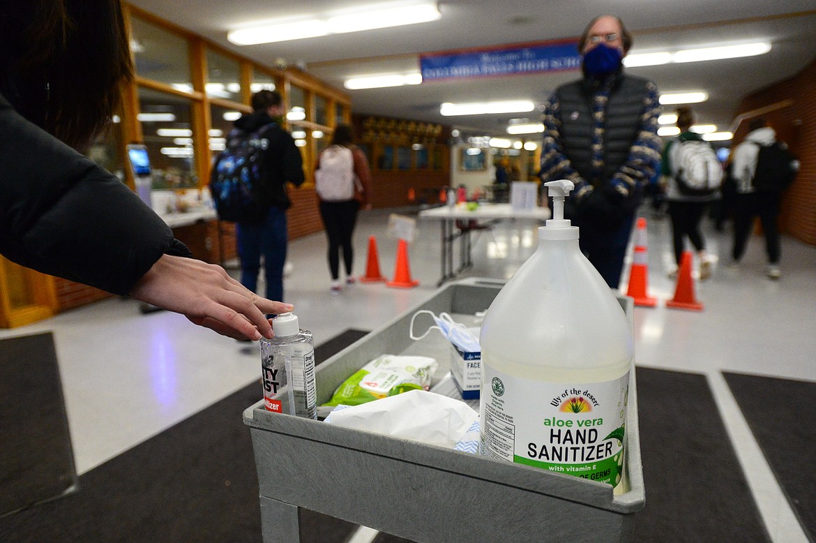 A student sanitizes their hands as part of the COVID-19 screening process at Columbia Falls High School on Wednesday, Jan. 20. (Casey Kreider/Daily Inter Lake)