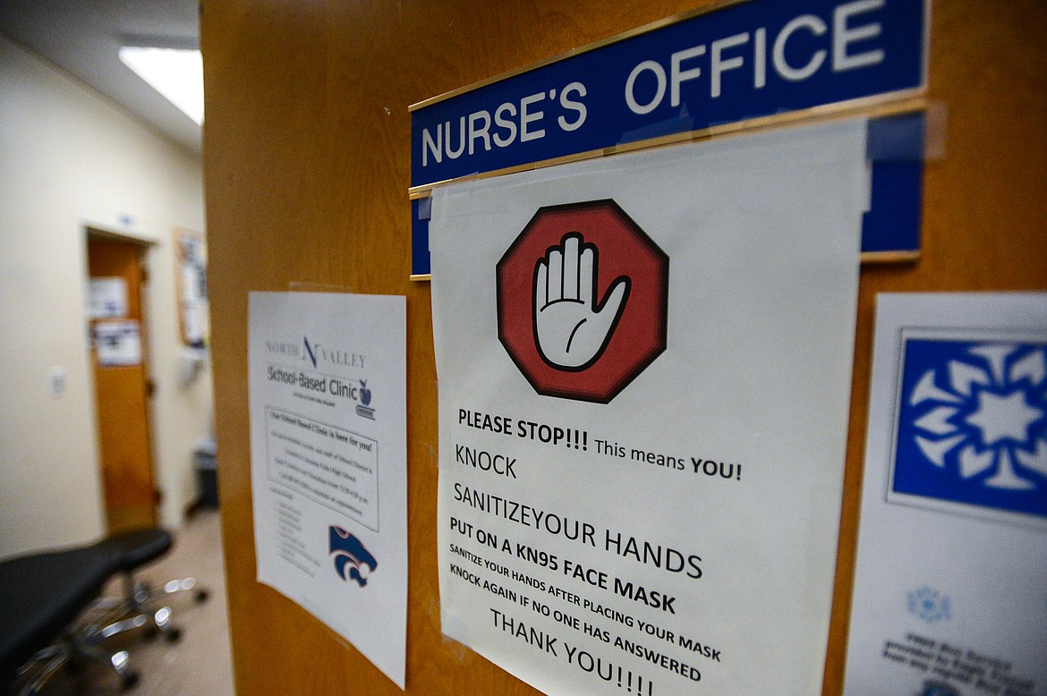 The entrance to the school nurse's office with a sign instructing students to knock, sanitize their hands and put on a face mask at Columbia Falls High School on Wednesday, Jan. 20. (Casey Kreider/Daily Inter Lake)