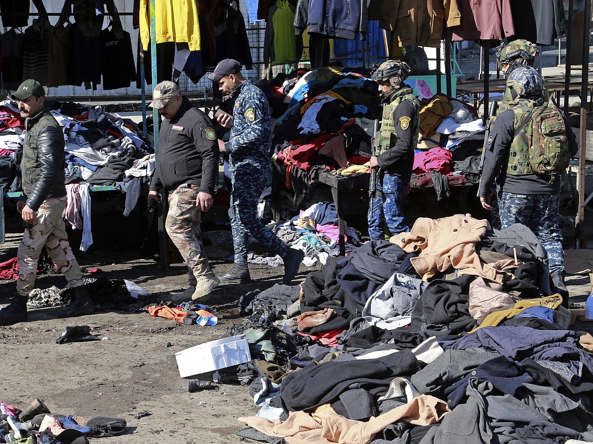 Security forces work at the site of a deadly bomb attack in Baghdad, Iraq, Thursday, Jan. 21, 2021. Iraq's military said twin suicide bombings at the Bab al-Sharqi commercial area in central Baghdad Thursday ripped through the busy market killing over two dozen and wounding over 70, with some in serious condition.