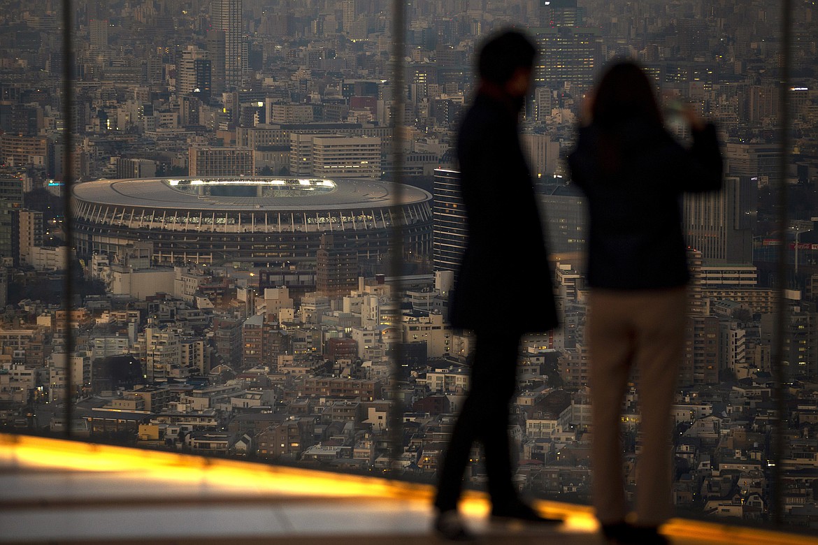 Japan National Stadium, where opening ceremony and many other events are planned for postponed Tokyo 2020 Olympics, is seen from a rooftop observation deck Thursday, Jan. 21, 2021, in Tokyo. The postponed Tokyo Olympics are to open in just six months. Local organizers and the International Olympic Committee say they will go ahead on July 23. But it’s still unclear how this will happen with virus cases surging in Tokyo and elsewhere around the globe.