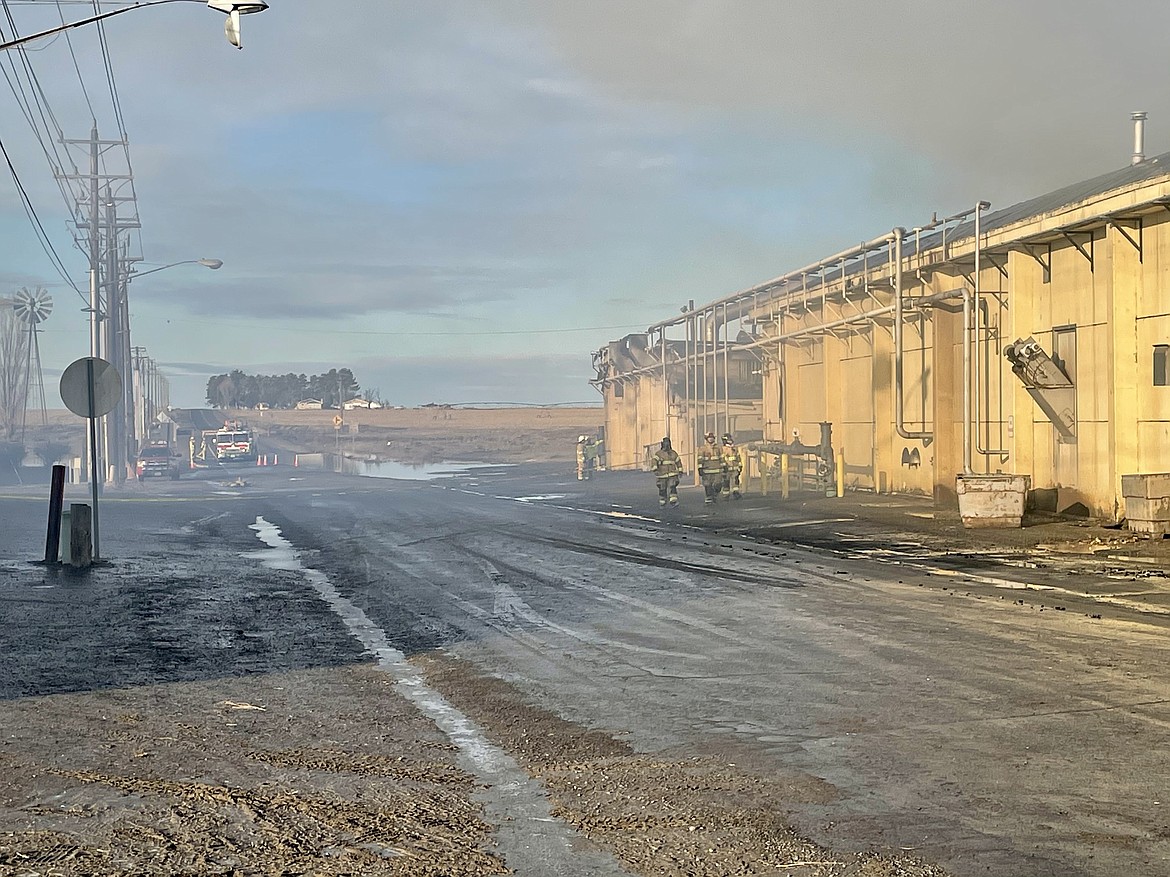 The Washington Potato Co. facility in Warden still smolders the next morning and smoke fills the air after a fire broke out in a potato dehydrator the afternoon of Jan. 21, prompting a response from fire departments across Grant and neighboring Adams counties.