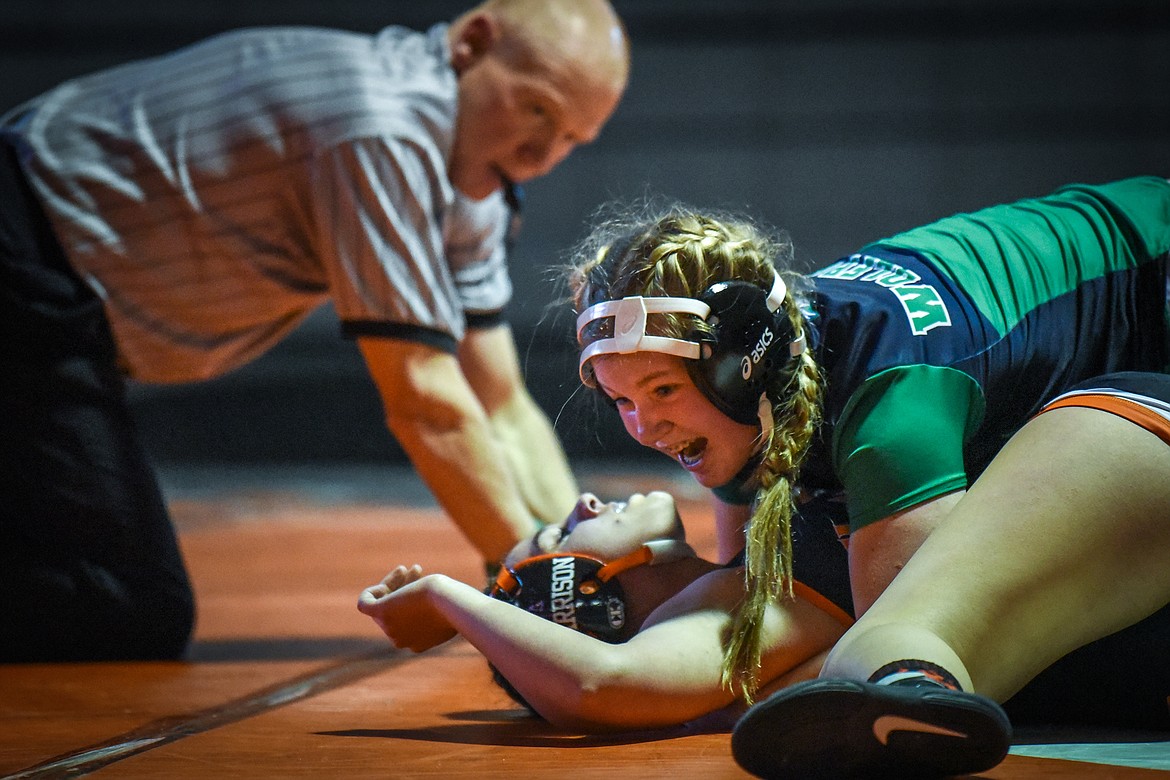 Glacier's McKenna McCarthy celebrates after a pin against Flathead's Sara Harrison at 152 lbs. at Flathead High School on Friday. (Casey Kreider/Daily Inter Lake)