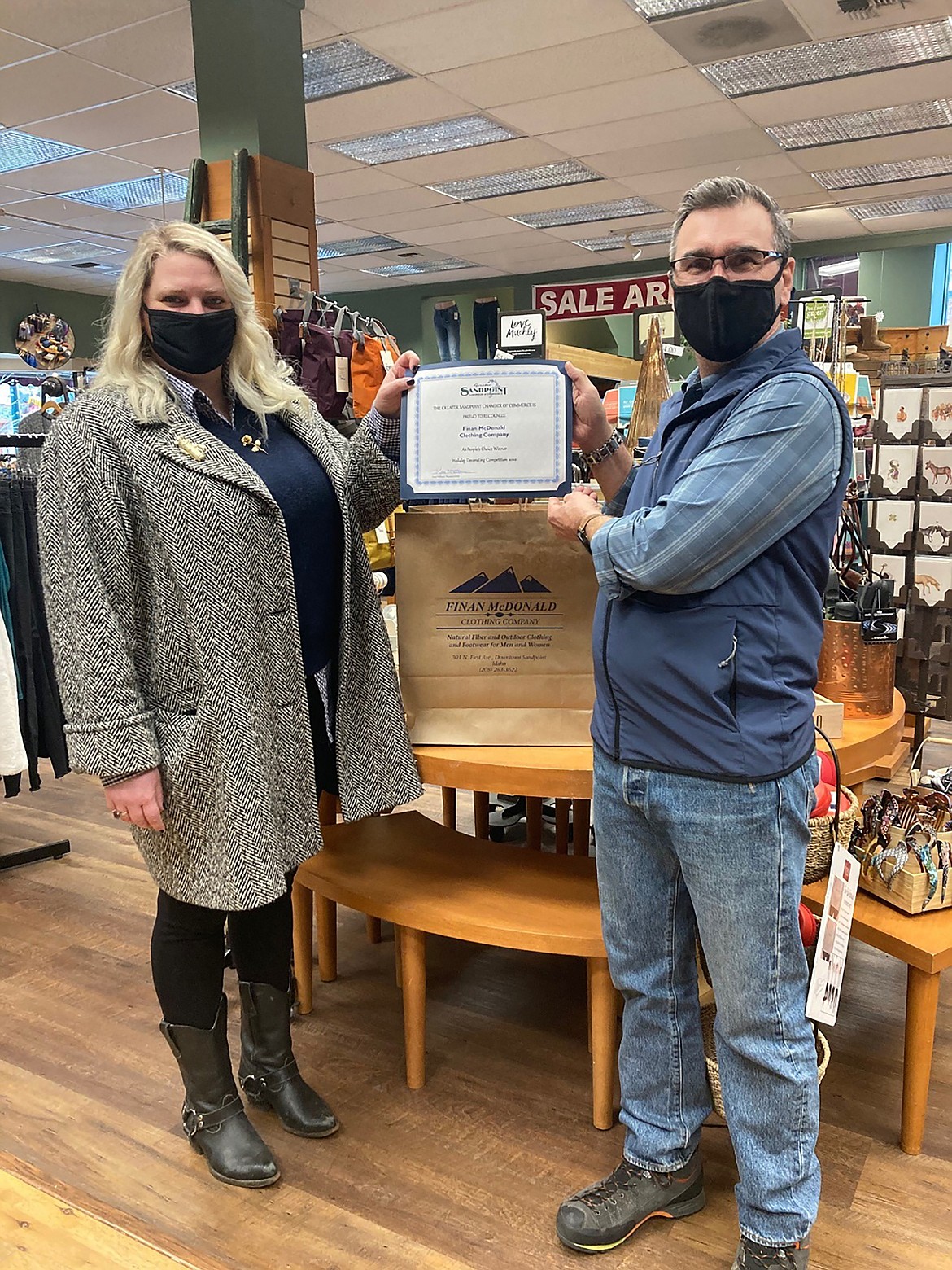 Greater Sandpoint Chamber of Commerce staffer Ricci Witte presents Finan McDonald with the 2020 People’s Choice certificate.