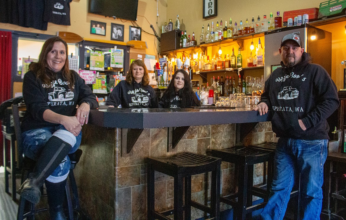 Uggie Boo’s Basin Street Bistro owner Kamela Farmer, employees Rachel Clark, Rilee Kassman, and family friend/ associate Ted Schuler stand by the bar in the empty restaurant on Friday afternoon.