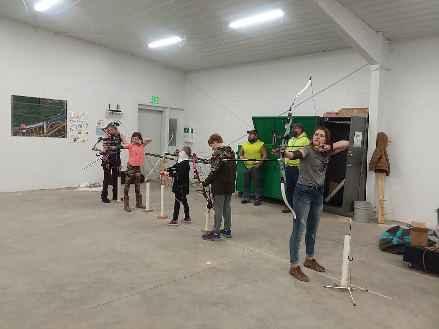 From left, are Mineral County 4-H archery competitors Haley Kruger, James Kelly, Keegan Kruger, Truman Traeder and Kodi Kelly. Instructors Ladd Nakasone and ‘Rusty’ Parkin are in the back. (Monte Turner/Mineral Independent)