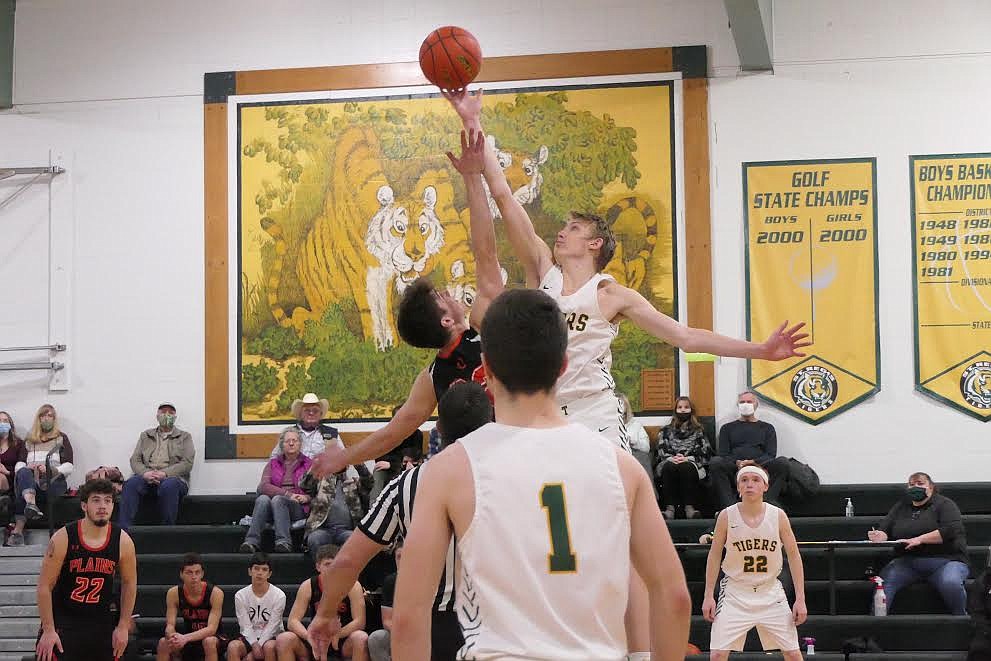 St. Regis center Andrew Sanford controls the opening tip over Plains' forward Nathan Feliksa Friday afternoon in St. Regis. (Chuck Bandel/Valley Press)