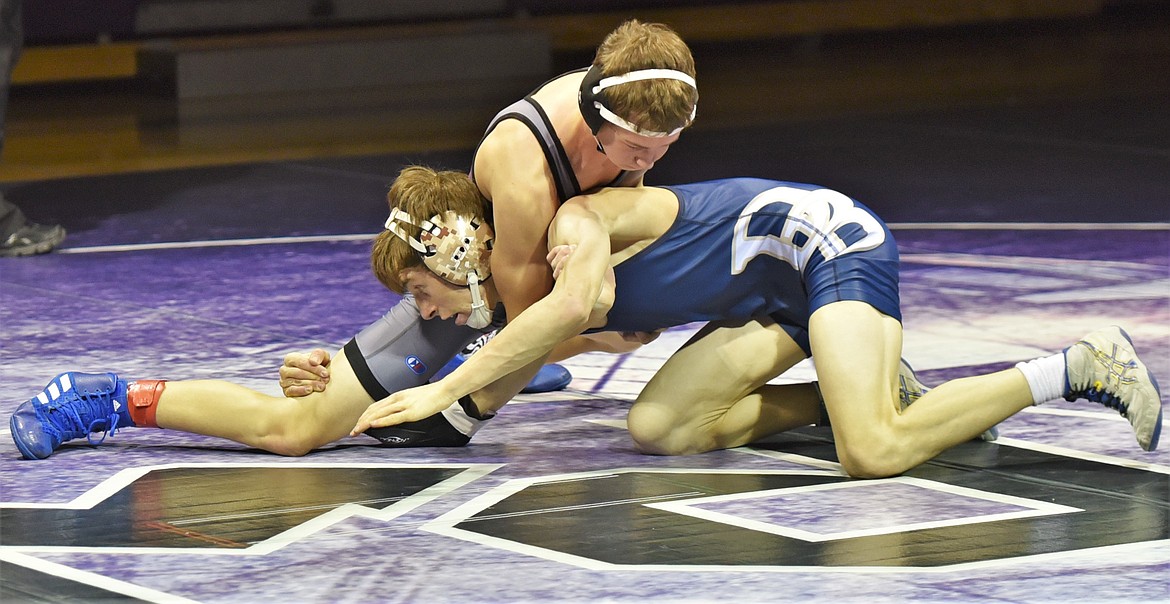 Cole Cross of Polson tries to control Dillon's Hunter Barnes during their 113-pound varsity match. Barnes won by fall. (Scot Heisel/Lake County Leader)