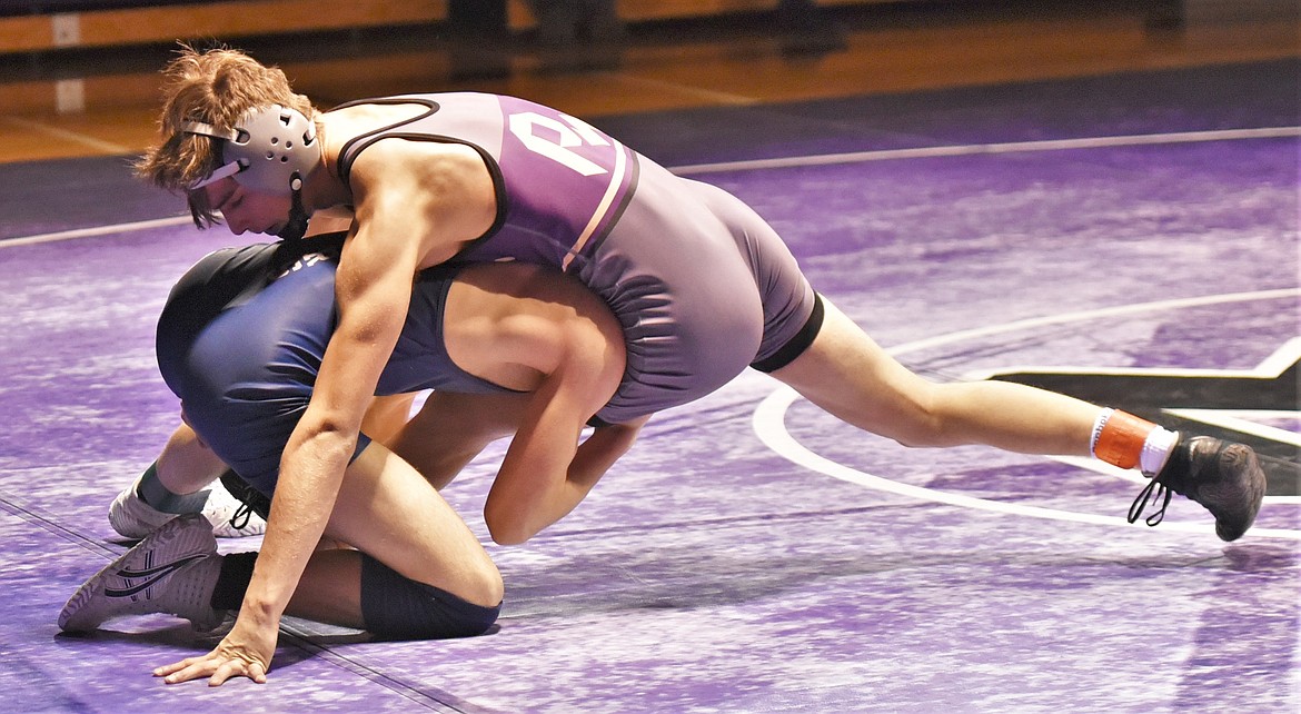 Masyn Cowell spreads out his base during his varsity 126-pound match against Noah Huffaker of Dillon in January. (Scot Heisel/Lake County Leader)