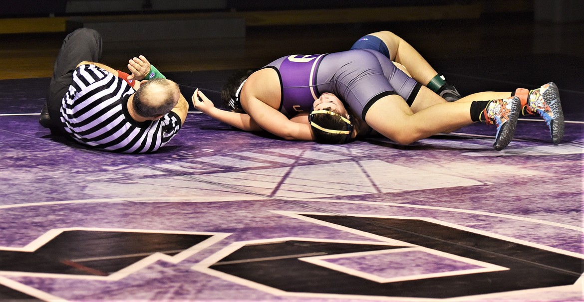 Polson's Jamison Webster pins Jesse Hughes of Dillon to win their 205-pound match. (Scot Heisel/Lake County Leader)