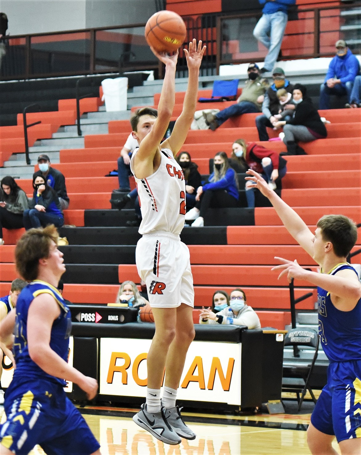 Ronan senior Zarec Couture (20) puts up a 3-pointer over Dillon defenders Ryker McElmurry , left, and Cy Stevenson. (Scot Heisel/Lake County Leader)