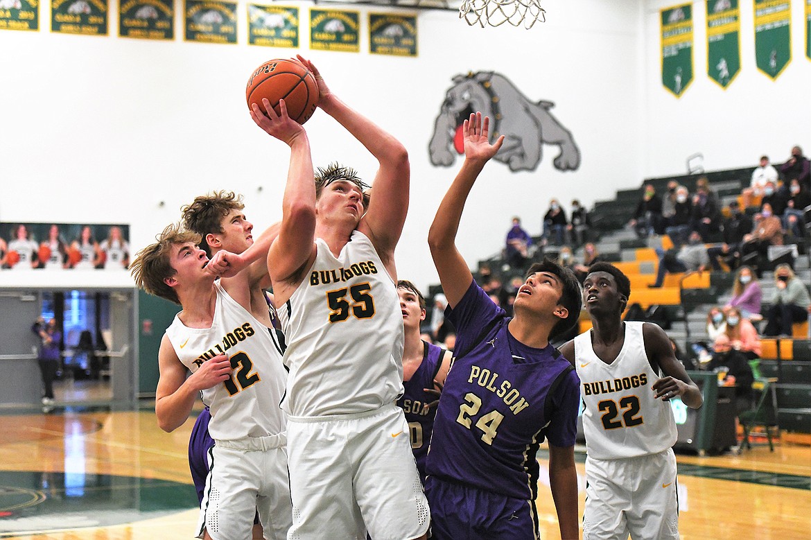 Bulldog junior Talon Holmquist, backed up by Logan Conklin (12) and Marvin Kimera (22) goes up for the shot against Polson at home Saturday night. (Jeff Doorn photo)