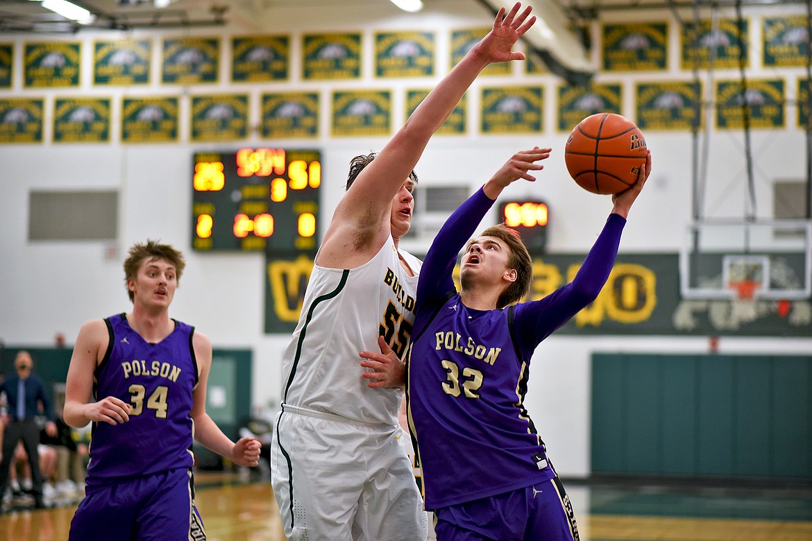 Polson's Colton Graham looks to score over Bulldog big man Talon Holmquist on Saturday at Whitefish. (Whitney England/Whitefish Pilot)