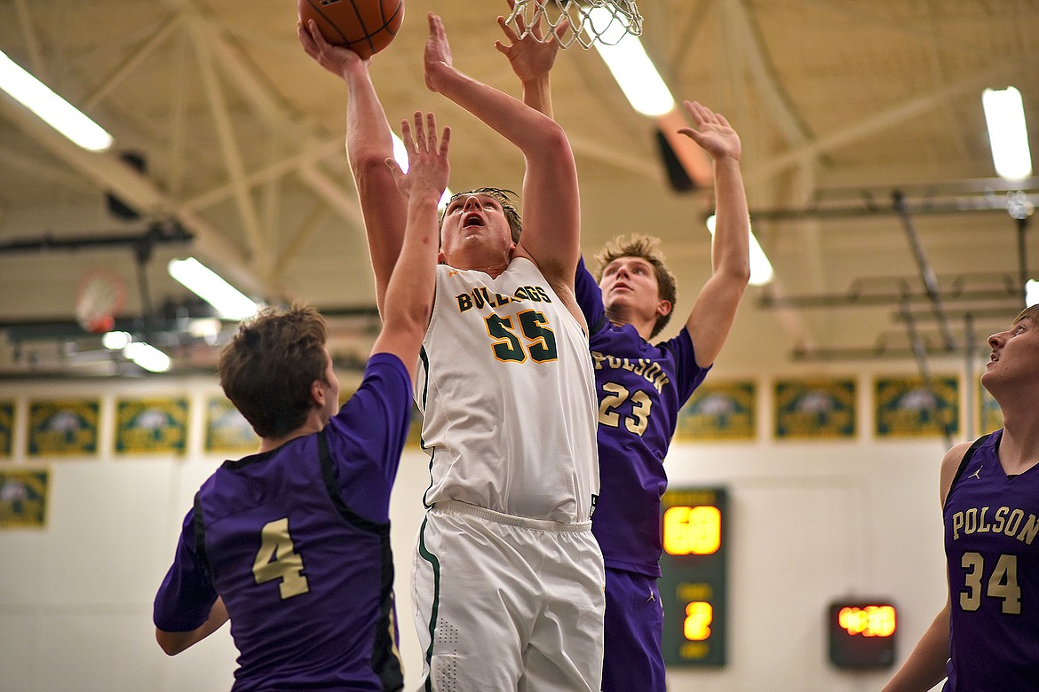 Whitefish's Talon Holmquist muscles his way to the basket over the Polson defense on his way to a team-high 18 points in the game Saturday. (Whitney England/Whitefish Pilot)