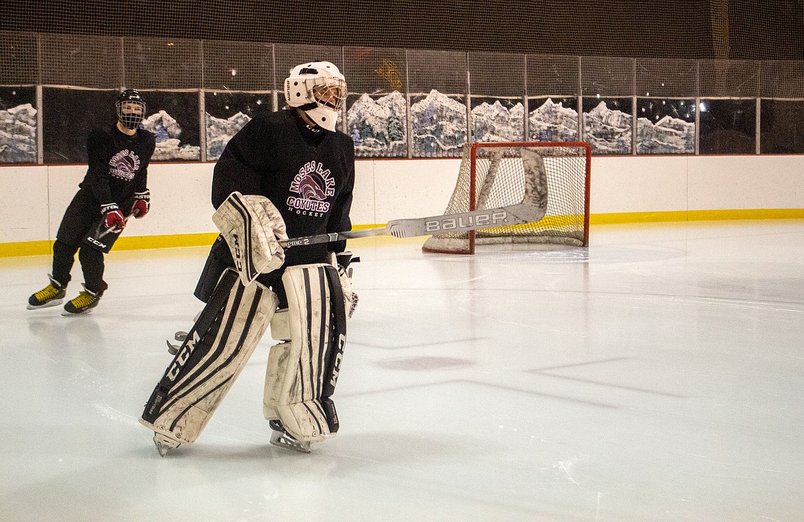 Moses Lake Coyotes 18U goalie Jacob Strevy makes his way around the ice rink in Moses Lake as he warms up for practice on Monday evening.